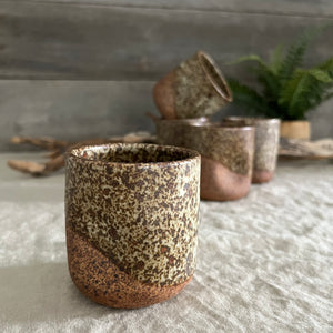 Handmade stoneware pottery. Dark speckled squish cup.