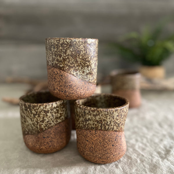 Handmade stoneware pottery. Dark speckled squish cup.