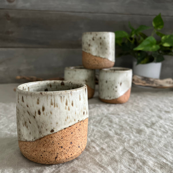 Handmade stoneware pottery. White speckled squish cups.