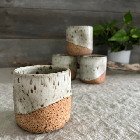 Handmade stoneware pottery. White speckled squish cups.