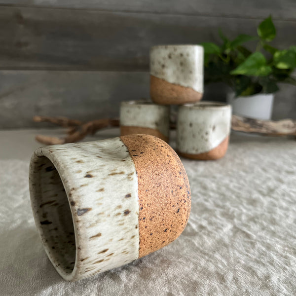 Handmade stoneware pottery. White speckled squish cups.