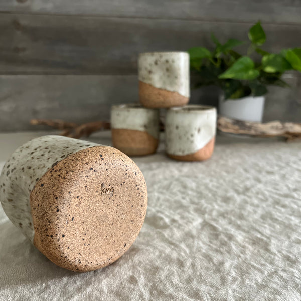 Handmade stoneware pottery. White speckled squish cups.