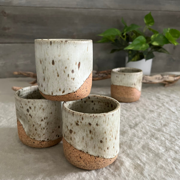 Handmade stoneware pottery. White speckled squish cups.