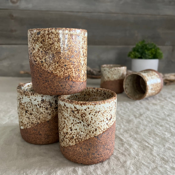 Handmade stoneware pottery. White speckled squish cups.