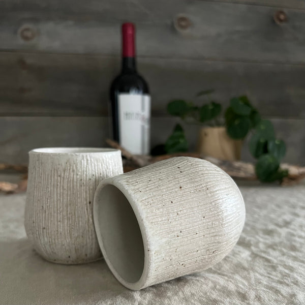 Handmade stoneware pottery. White textured stemless wine cup set.