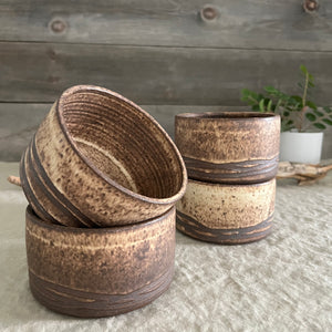 Handmade stoneware pottery. Rustic cereal bowls made of dark brown clay.