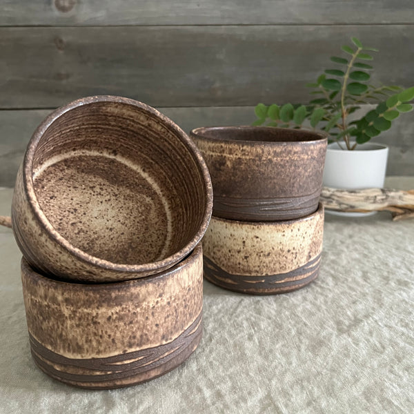 Handmade stoneware pottery. Rustic cereal bowls made of dark brown clay.