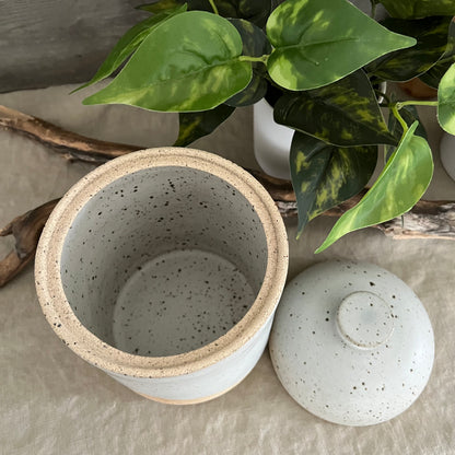 Handmade stoneware pottery. White speckled lidded canister.