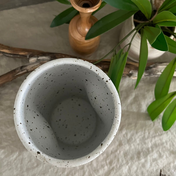 Handmade stoneware pottery. White speckled squish vase.